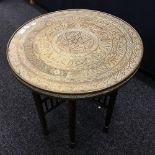An Eastern brass topped folding table