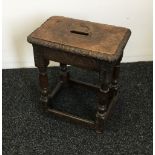 A carved oak joint stool