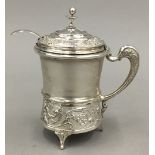 An 800 silver lidded mustard with glass liner and 800 silver spoon en-suite (107 grammes total