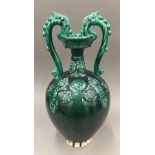 A green drip glazed pottery twin handled vase