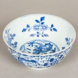 A Chinese blue and white porcelain bowl, worked with dragons amongst stylised clouds,