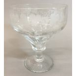 A 19th century oversized wine glass, the bowl wheel engraved with fruiting vines. 18 cm high.