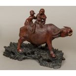 A 19th century Chinese well carved group of boys riding a water buffalo,