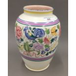 A Poole pottery vase decorated with birds and flowers in bright enamels,