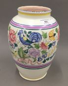 A Poole pottery vase decorated with birds and flowers in bright enamels,