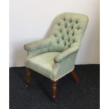 A Victorian upholstered button back armchair
