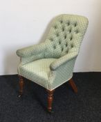 A Victorian upholstered button back armchair