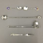 A sterling silver candle snuffer, a sterling pickle fork,