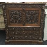 A Victorian carved oak side cupboard