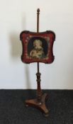 A Victorian mahogany pole screen with tapestry panel