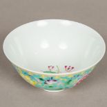 A Chinese porcelain bowl, worked with lotus strapwork on a turquoise ground,