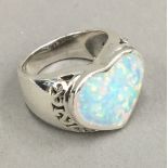 An opal heart shaped ring