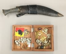 A quantity of various cap badges, kukri, etc.