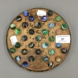 A vintage solitaire board with marbles