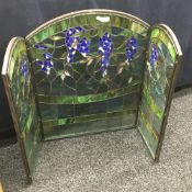 A stained leaded glass triptych fire screen