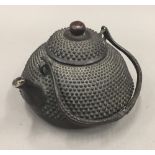 A cast metal teapot