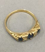 A gold five stone diamond and sapphire ring (3.