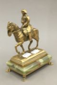 A brass model of Napoleon on an onyx plinth