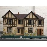 A vintage dolls house and contents
