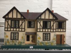 A vintage dolls house and contents