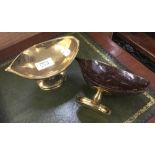 A pair of pedestal bon bon dishes formed from brass mounted coconuts