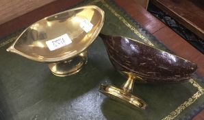 A pair of pedestal bon bon dishes formed from brass mounted coconuts