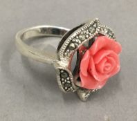 A silver and coral ring