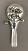 A silver moon rattle