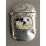 A silver vesta depicting a dog