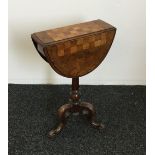 A Victorian walnut folding pedestal games table