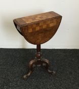 A Victorian walnut folding pedestal games table