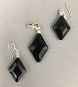 A pair of silver dress earrings and pendant en-suite