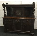 A late 19th/early 20th century carved oak court cupboard