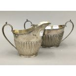 A silver sugar bowl and cream jug