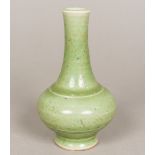 A Chinese porcelain vase, with allover celadon glaze and moulded band decoration. 16 cm high.