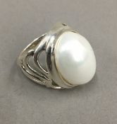 A silver and pearl dress ring