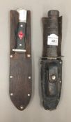 A vintage American Commando knife in leather sheath,