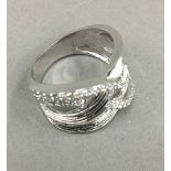 A silver and cubic zirconia crossover ring