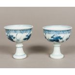 A pair of Chinese blue and white porcelain stem cups Both figurally decorated,