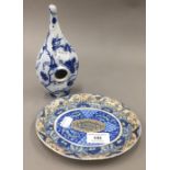 A rare 19th century English pottery blue and white transfer feeding bottle and a 19th century