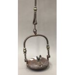 An early 19th century wrought iron lenticular lamp