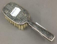 A silver baby's brush