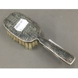 A silver baby's brush