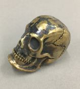 A brass skull vesta