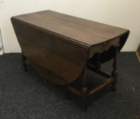 A large 18th century and later oak gate leg table