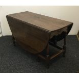 A large 18th century and later oak gate leg table