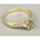 A 9 ct gold peridot and diamond ring (2 grammes total weight)