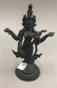 A bronze figure of deity with an instrument