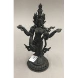 A bronze figure of deity with an instrument