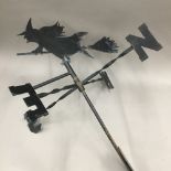 A weather vane topped with a witch on a broomstick